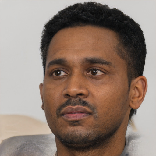 Neutral black young-adult male with short  black hair and brown eyes