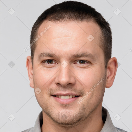 Joyful white young-adult male with short  brown hair and brown eyes