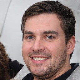 Joyful white adult male with short  brown hair and brown eyes