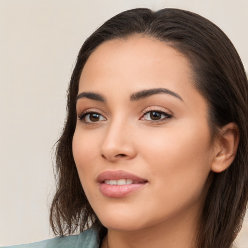 Joyful latino young-adult female with long  brown hair and brown eyes