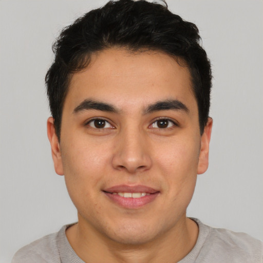 Joyful latino young-adult male with short  brown hair and brown eyes