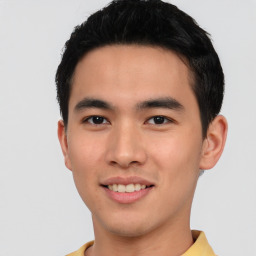 Joyful asian young-adult male with short  black hair and brown eyes