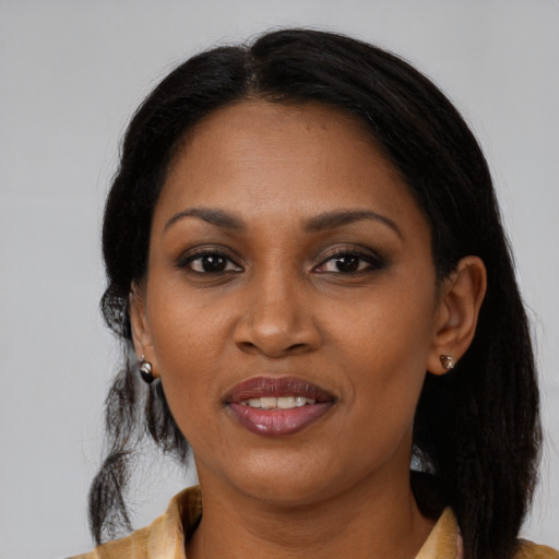 Joyful black young-adult female with medium  brown hair and brown eyes