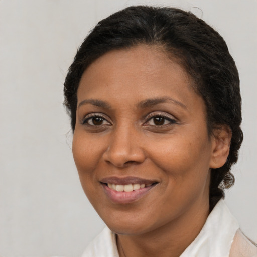 Joyful latino adult female with medium  brown hair and brown eyes