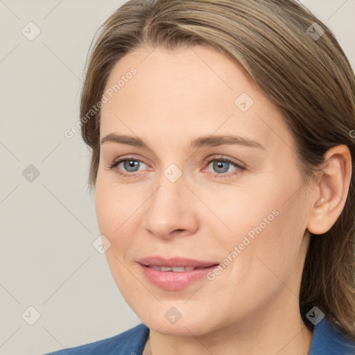 Joyful white young-adult female with medium  brown hair and blue eyes