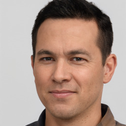 Joyful white adult male with short  brown hair and brown eyes