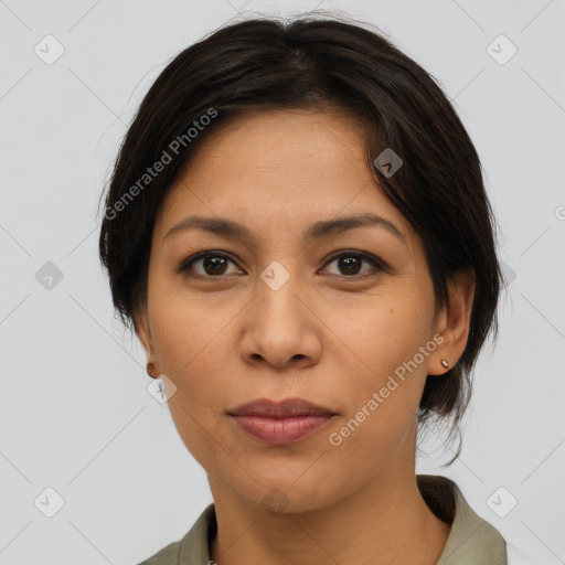 Joyful latino adult female with medium  brown hair and brown eyes