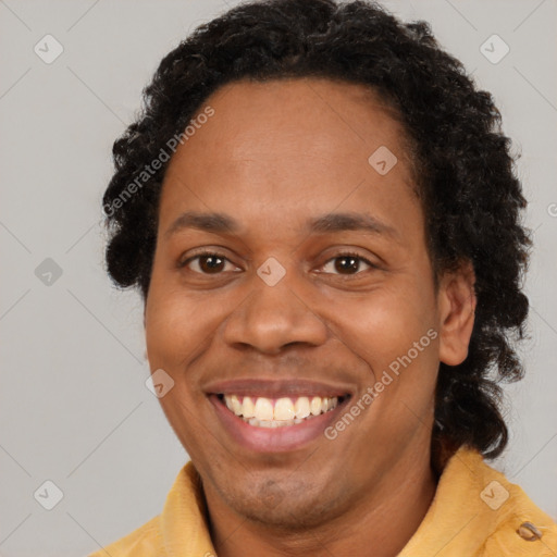 Joyful black young-adult male with short  brown hair and brown eyes