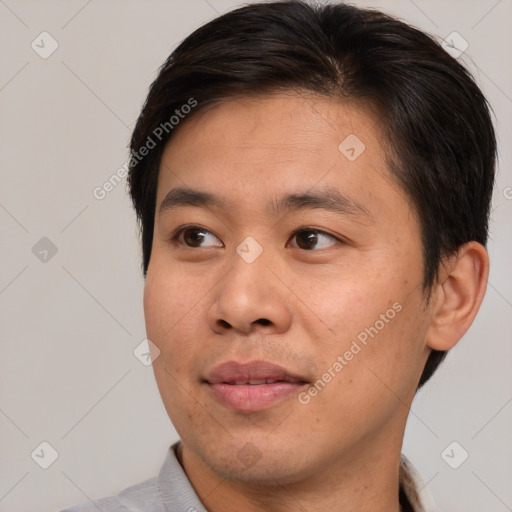 Joyful asian young-adult male with short  brown hair and brown eyes