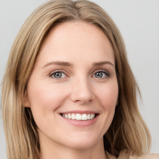 Joyful white young-adult female with long  brown hair and green eyes