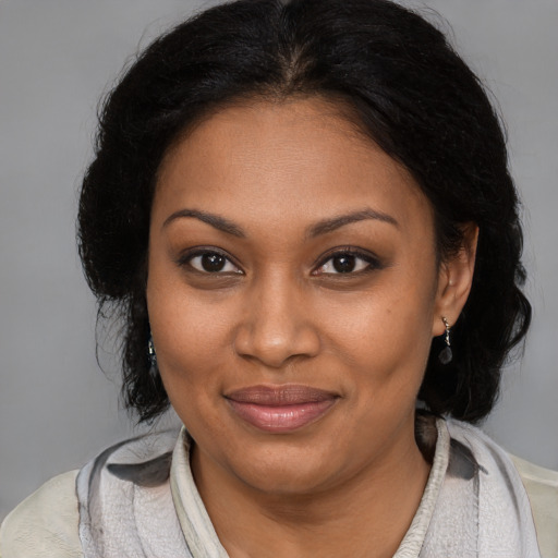 Joyful black young-adult female with medium  brown hair and brown eyes