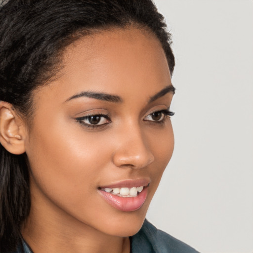 Joyful latino young-adult female with long  brown hair and brown eyes