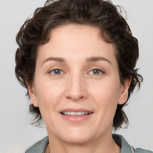 Joyful white young-adult female with medium  brown hair and green eyes