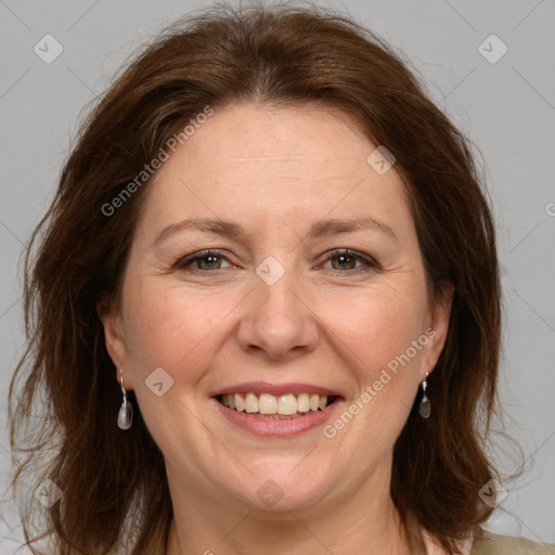 Joyful white adult female with medium  brown hair and grey eyes