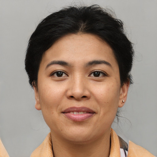 Joyful asian young-adult female with short  brown hair and brown eyes