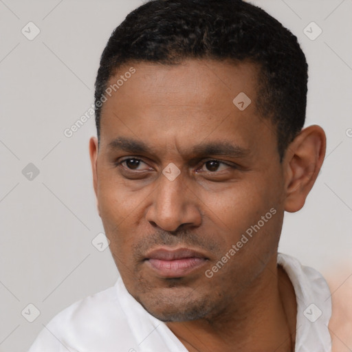 Neutral latino young-adult male with short  black hair and brown eyes