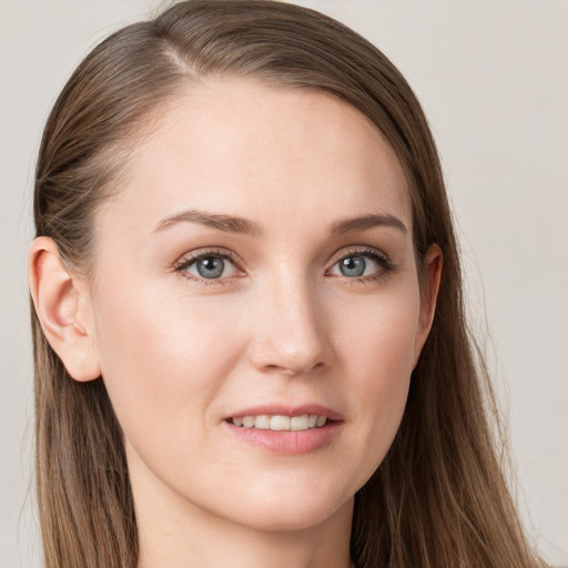 Joyful white young-adult female with long  brown hair and grey eyes