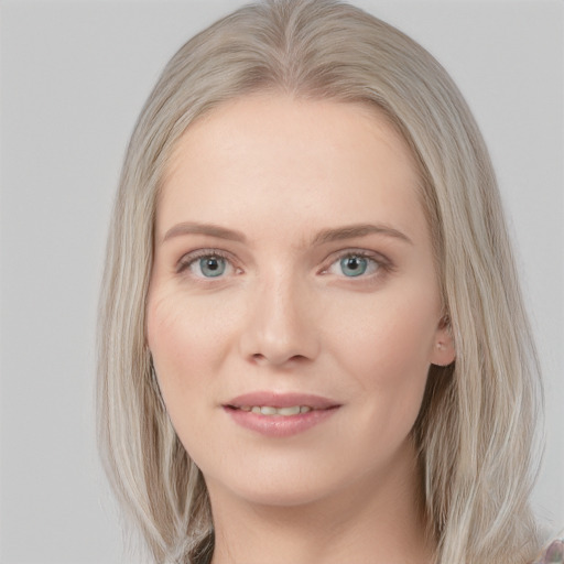 Joyful white young-adult female with long  brown hair and blue eyes