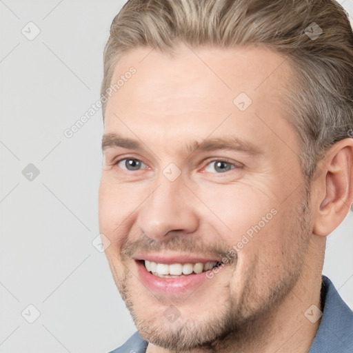 Joyful white adult male with short  brown hair and brown eyes