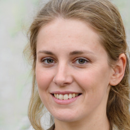 Joyful white young-adult female with medium  brown hair and blue eyes