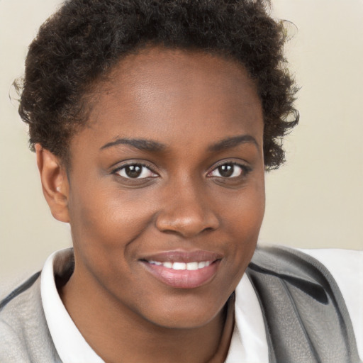 Joyful black young-adult female with short  brown hair and brown eyes