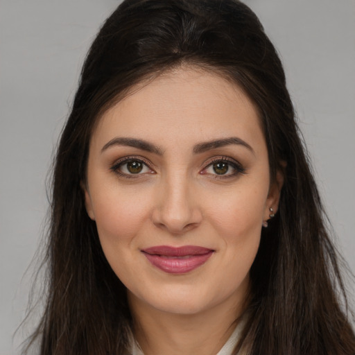 Joyful white young-adult female with long  brown hair and brown eyes