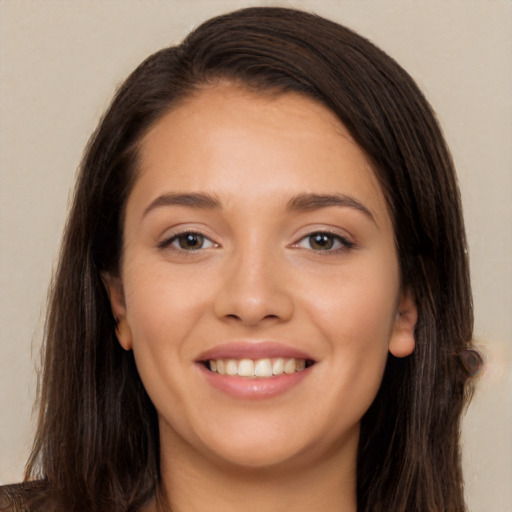 Joyful white young-adult female with long  brown hair and brown eyes