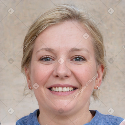 Joyful white adult female with medium  brown hair and blue eyes