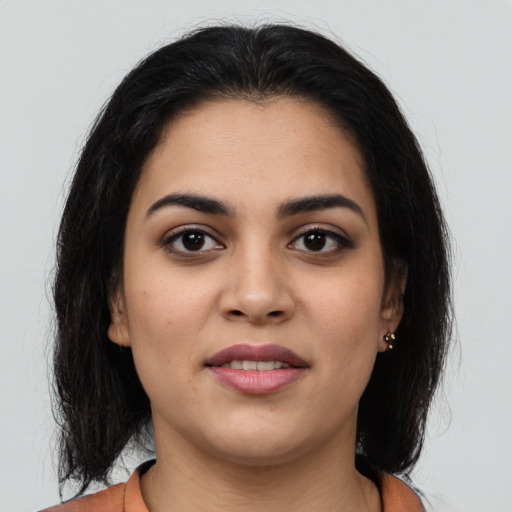 Joyful latino young-adult female with medium  brown hair and brown eyes