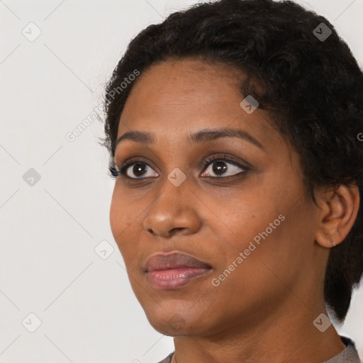 Joyful black young-adult female with short  black hair and brown eyes