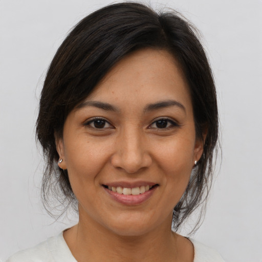 Joyful asian adult female with medium  brown hair and brown eyes