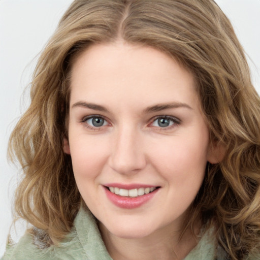 Joyful white young-adult female with medium  brown hair and green eyes