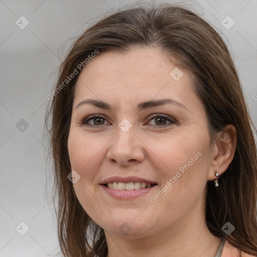 Joyful white adult female with medium  brown hair and brown eyes