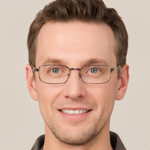 Joyful white young-adult male with short  brown hair and grey eyes