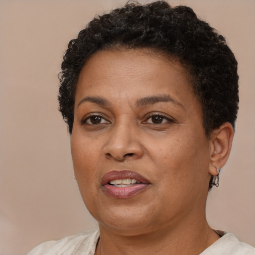 Joyful black adult female with short  brown hair and brown eyes