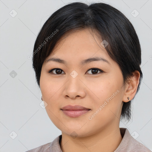 Joyful asian young-adult female with medium  black hair and brown eyes