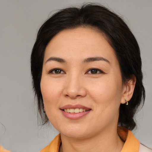 Joyful asian young-adult female with medium  brown hair and brown eyes