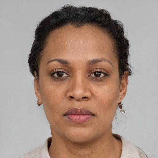 Joyful latino adult female with short  brown hair and brown eyes