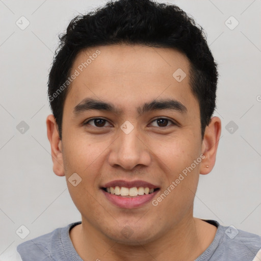 Joyful latino young-adult male with short  brown hair and brown eyes