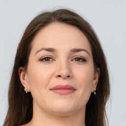 Joyful white young-adult female with long  brown hair and grey eyes