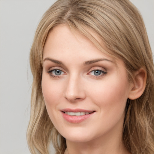 Joyful white young-adult female with long  brown hair and grey eyes