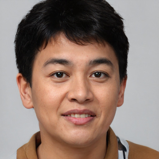 Joyful asian young-adult male with short  brown hair and brown eyes