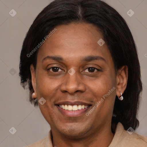 Joyful black adult female with medium  brown hair and brown eyes