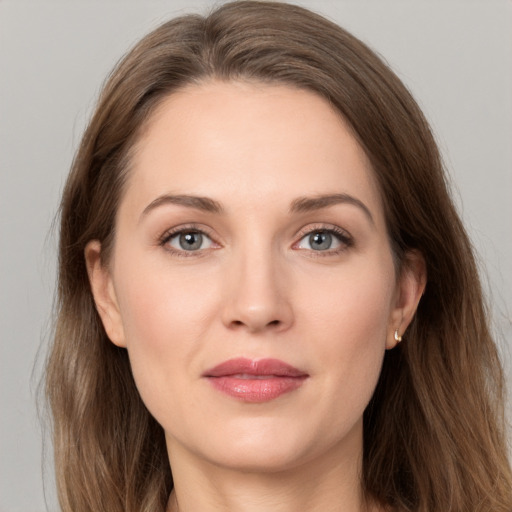 Joyful white adult female with long  brown hair and grey eyes