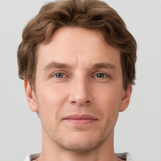 Joyful white adult male with short  brown hair and grey eyes