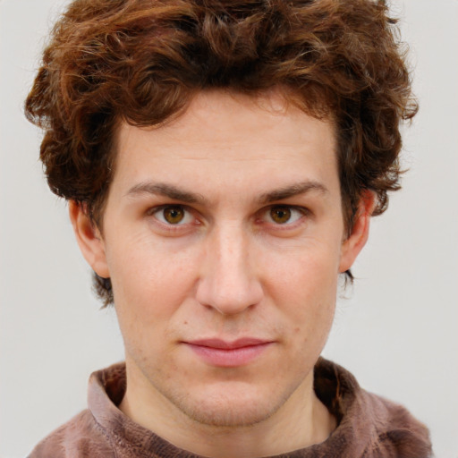 Joyful white young-adult male with short  brown hair and green eyes