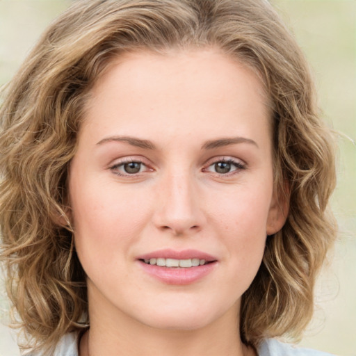 Joyful white young-adult female with medium  brown hair and green eyes