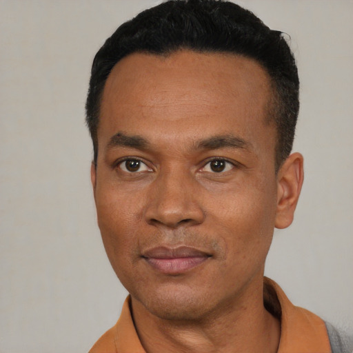 Joyful latino adult male with short  black hair and brown eyes