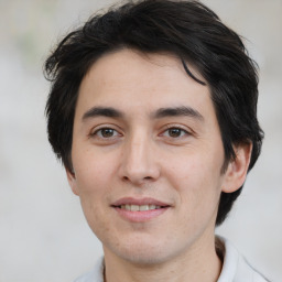 Joyful white young-adult male with medium  brown hair and brown eyes