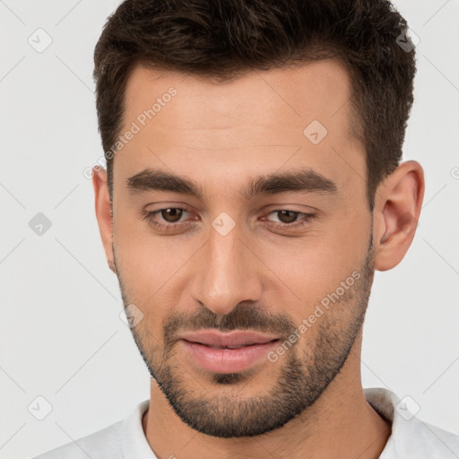 Joyful white young-adult male with short  brown hair and brown eyes